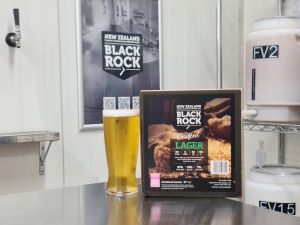 New Zealand Black Rock Lager beer can and glass on a bar counter with a blurred background